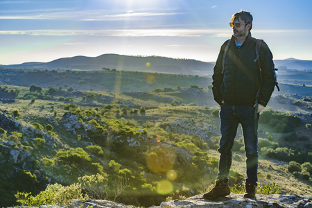 LAVALLEJA, URUGUAY, AUGUST - 2017 - Slim tall adult man watching the view at top of hill at countryside landscapeのeditorial素材
