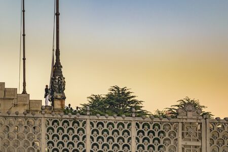 MONTEVIDEO, URUGUAY, SEPTEMBER - 2017 - Long distant shot of military man raising the flagのeditorial素材