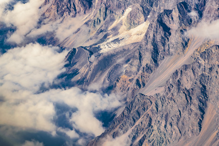 Aerial view from window plane of andes range mountains over chilean territory.の写真素材