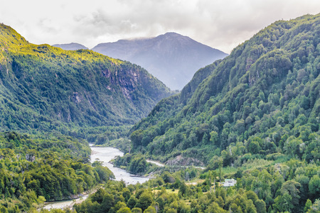 Forest and andes mountains landscape scene at chilean patagonian territoryの写真素材