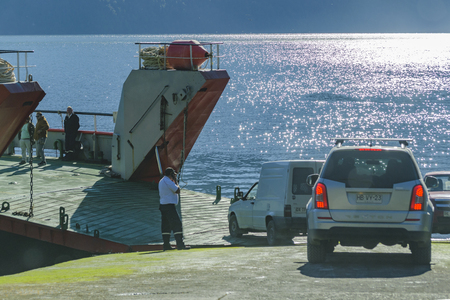LOS LAGOS, CHILE, APRIL - 2017 - Vehicles entering at ferry which cross the frojd at Caleta gonzalo, Chileのeditorial素材