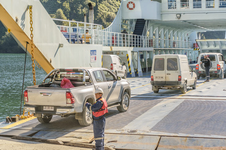 LOS LAGOS, CHILE, APRIL - 2017 - Vehicles entering at ferry which cross the frojd at Caleta gonzalo, Chileのeditorial素材