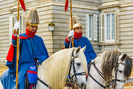 MADRID, SPAIN, DECEMBER - 2017 - Two royal palace guards mounted on horsebacks at Royal Palace in Madrid city, Spainのeditorial素材