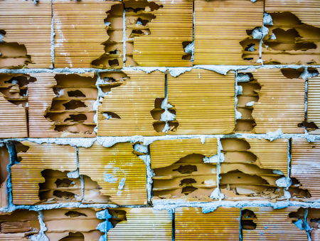 Front view of ancient cracked brick wall surface