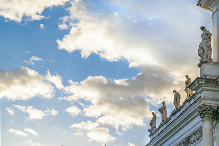 Low angle shot detail view of sculptures at top of ancient buildingの写真素材