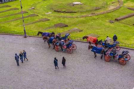 ROME, ITALY, DECEMBER - 2017 - High angle view of touristic carriages at coliseum piazza at Rome city, Italyのeditorial素材