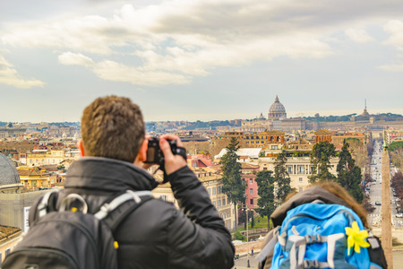 Couple taking photos of Rome cityscape from monte pincio viewpoint.の写真素材