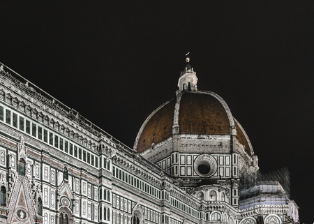 Low angle view night scene of famous santa maria dei fiore cathedral in Florence, Italyの写真素材