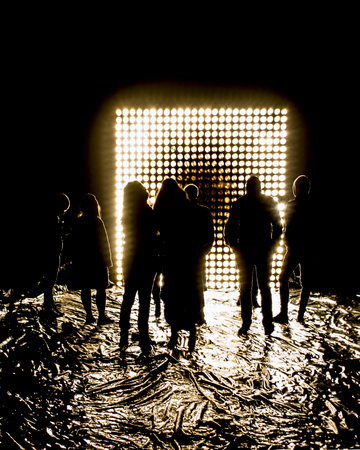 Night scene high contrast photo of people at outdoor contemporary art lights and music performance in Rome city, Italyの写真素材