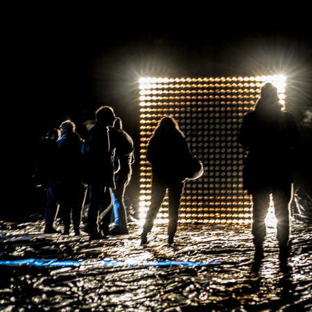Night scene high contrast photo of people at outdoor contemporary art lights and music performance in Rome city, Italyの写真素材