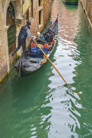 VENICE, ITALY, JANUARY - 2018 - Gondolier taking tourist at small canal in venice city, Italyのeditorial素材