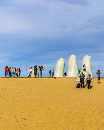 PUNTA DEL ESTE, URUGUAY, OCTOBER - 2018 -  Tourist at most famous landmark monument located at la brava beach in punta del este city, Uruguayのeditorial素材