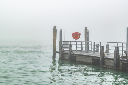 Empty boat wooden station at grand channel of venice city, Italyの写真素材