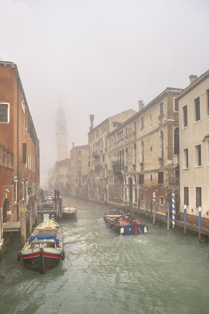 Foggy morning urban scene at small channel at venice city, Italyのeditorial素材