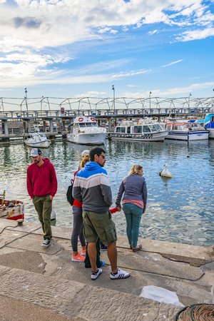 PUNTA DEL ESTE, URUGUAY, OCTOBER - 2018 - Group of people at port in punta del este city, Uruguayのeditorial素材