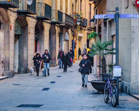 BARCELONA, SPAIN, JANUARY - 2018 - Narrow street surrounded by medieval buildings at gothic district in barcelona city, spainのeditorial素材