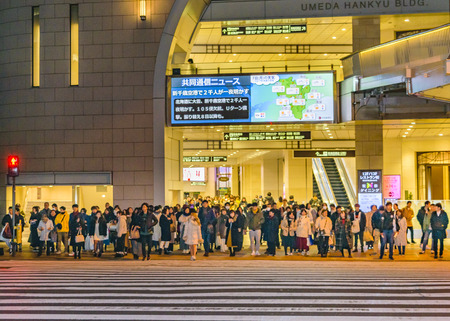 OSAKA, JAPAN, JANUARY - 2019 - Urban night scene with people waiting to cross the street, osaka city, japanのeditorial素材