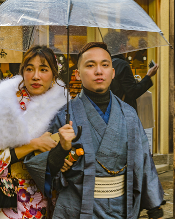 KYOTO, JAPAN, JANUARY - 2019 - Young japanese couple dressing traditional costume walking at kyoto street, japanのeditorial素材