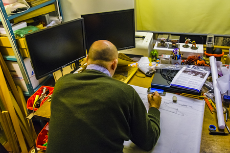 MONTEVIDEO, URUGUAY, JUNE - 2019 - Interior scene of adult artist sketching his next artwork at workshopのeditorial素材