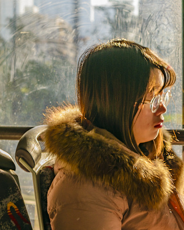 HANGZHOU, CHINA, DECEMBER - 2018 - Young chinese woman sleeping at bus in hangzhou city, china