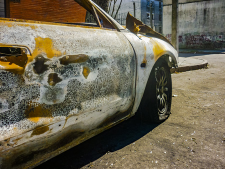 MONTEVIDEO, URUGUAY, AUGUST - 2019 - Burnt car parked at street in montevideo city, uruguayのeditorial素材