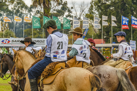 MONTEVIDEO, URUGUAY, SEPTEMBER - 2019 - Teens and kids riding horses at traditional rural exhibition at prado neighborhood in montevideo city, uruguayのeditorial素材