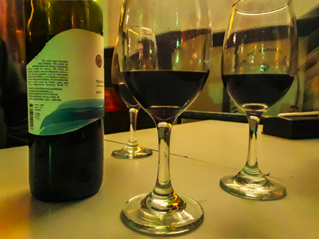 MONTEVIDEO, URUGUAY, AUGUST - 2019 - Two wine cups at table interior night sceneのeditorial素材
