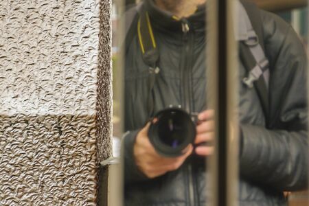 Adult man taking an unusual reative angle perspective selfieの写真素材