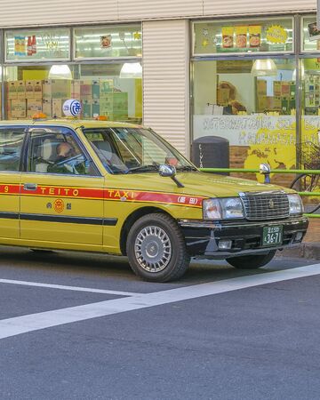 TOKYO, JAPAN, JANUARY - 2019 - Yellow taxi at road at famous ginza neighborhood in tokyo city, japanのeditorial素材