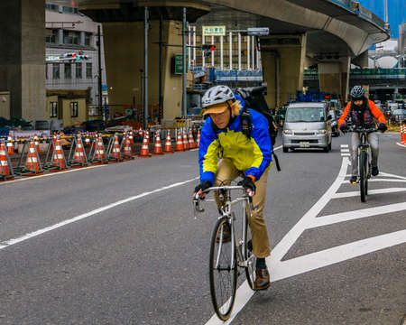 TOKYO, JAPAN, JANUARY - 2019 - People riding bicycle at street in shibuya neighborhood in tokyo city, japanのeditorial素材