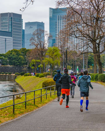 TOKYO, JAPAN, JANUARY - 2019 - People running at exterior imperial palace park in chiyoda district, tokyo, japanのeditorial素材