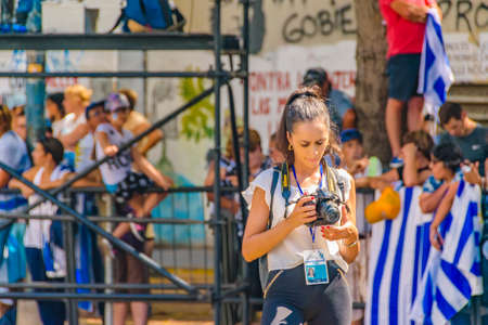 MONTEVIDEO, URUGUAY, MARCH - 2020 - Young woman press photographer watching his photos at...