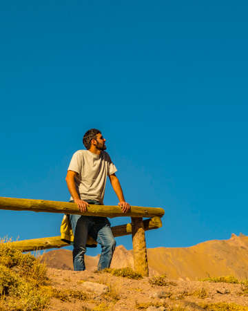 MENDOZA, ARGENTINA, APRIL - 2019 - Young man looking the landscape at sightseeing in aconcagua national park, mendoza province, argentinaのeditorial素材