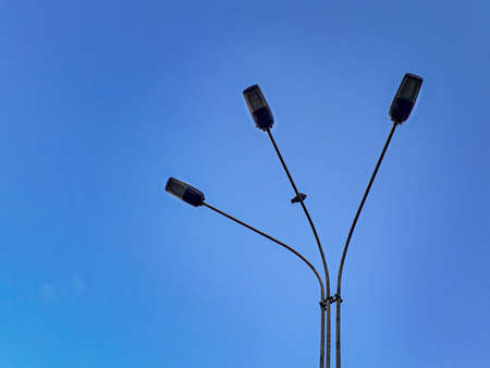 Low angle shoy streetlight over clean blue sky background