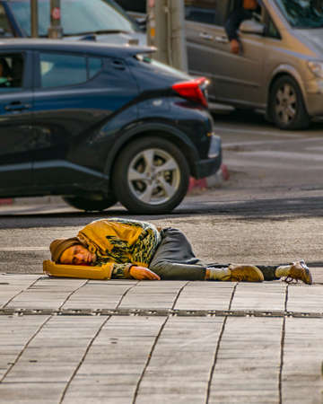 TEL AVIV, ISRAEL, DECEMBER - 2019 - Urban scene homeless sleeping at sidewalk, tel aviv, israel
