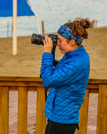 JERUSALEM, ISRAEL, DECEMBER - 2019 - Young woman taking photos, kalia beach, israelのeditorial素材