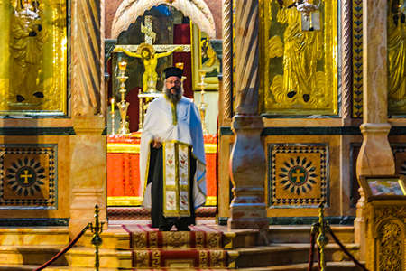 JERUSALEM, ISRAEL, DECEMBER - 2019 - Priest at interior of holy sepulcher church, old jerusalem cityのeditorial素材