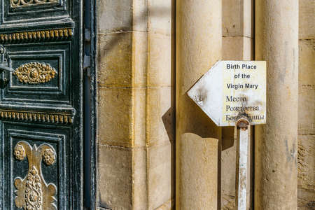 Signpost and door of virgin mary birth place, old jerusalemのeditorial素材