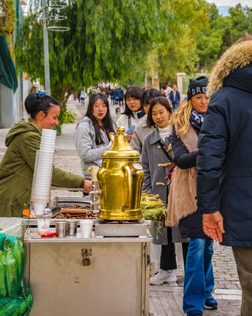ATHENS, GREECE, DECEMBER - 2019 - People buying traditional drink at peripatus street, plaka district, athens, greeceのeditorial素材