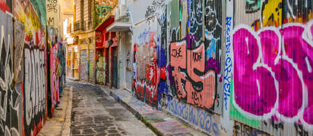 ATHENS, GREECE, JANUARY - 2020 - Empty narrow street with lots of graffities at walls at plaka...