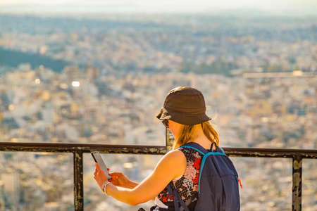 ATHENS, GREECE, JANUARY - 2020 - Young woman taking a selife at lycabettus hill viewpoint, athens, greeceのeditorial素材