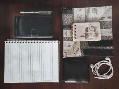 Top view wooden desk with organized personal objects