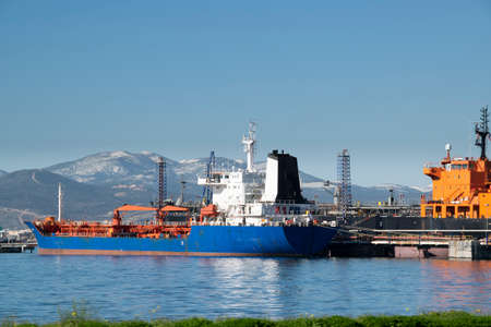 Small port and snowy mountain landscape scene at peloponnese district, greeceのeditorial素材
