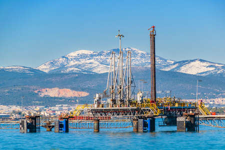 Small port and snowy mountain landscape scene at peloponnese district, greeceのeditorial素材