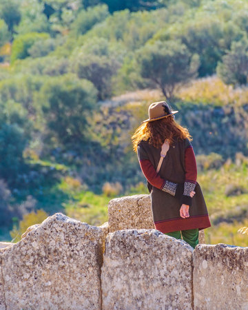 Back view woman standing at top of famous archaelogical micenas city, greeceのeditorial素材