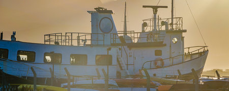 Antique ship parked at ushuaia port with andes range mountains in background, tierra del fuego,...