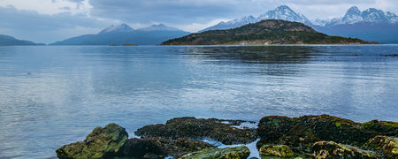 Islands and chile mountains landscape from zarategui cove, tierra del fuego, ushuaia, argentinaの写真素材