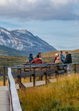 Ushuaia, Argentina; April 10 2022: Group of tourists talking at wooden road in Puerto Arias, Tierra del Fuego National Park, Ushuaia, Argentinaのeditorial素材