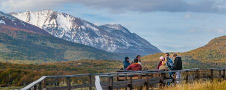 Ushuaia, Argentina; April 10 2022: Group of tourists talking at wooden road in Puerto Arias, Tierra del Fuego National Park, Ushuaia, Argentinaのeditorial素材