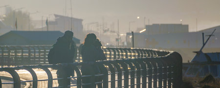 Group of tourists at highway promenade at misty morning day, Ushuaia, Tierra del Fuego, Argentinaの写真素材